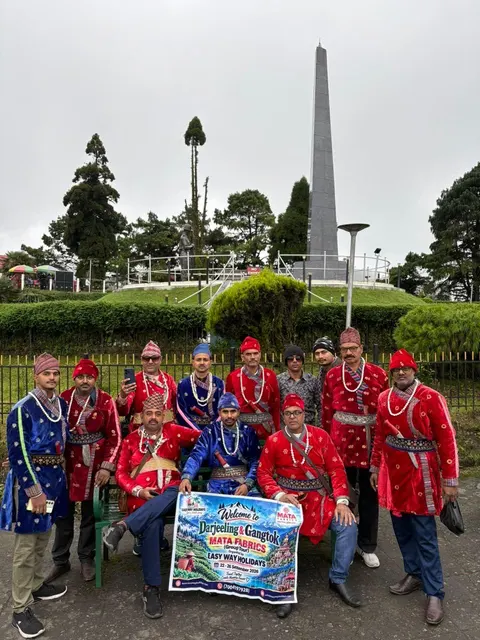 Easy Way Holidays tour group posing beside a landscaped monument
