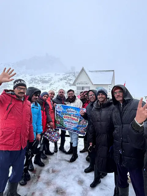 Travellers in winter clothing posing together in the snow