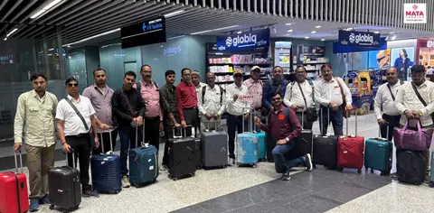 Tour group with luggage gathered outside a building before departure
