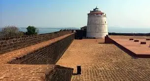 White lighthouse inside the stone walls of Fort Aguada in Goa