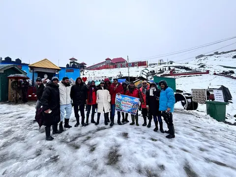 Group of travellers posing together in a snowy mountain setting