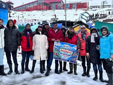 Travellers holding an Easy Way Holidays banner on a snow-covered slope