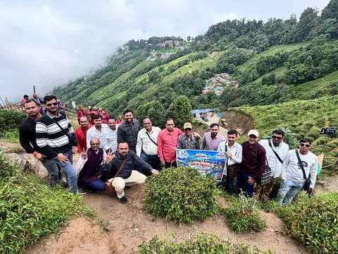 Easy Way Holidays group posing among green hills and flowering shrubs